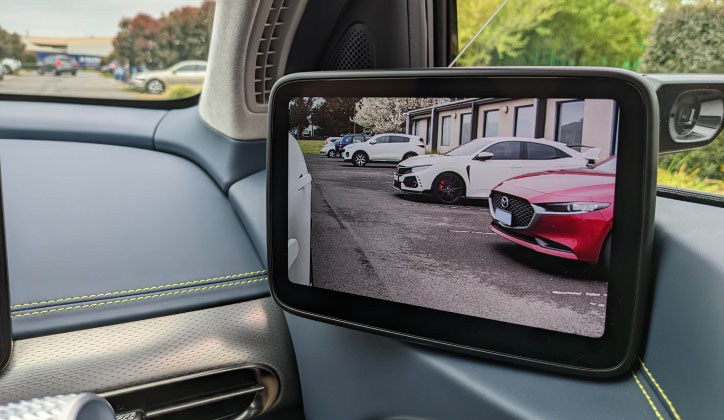 Digital side mirror in Genesis GV60 in a car park.